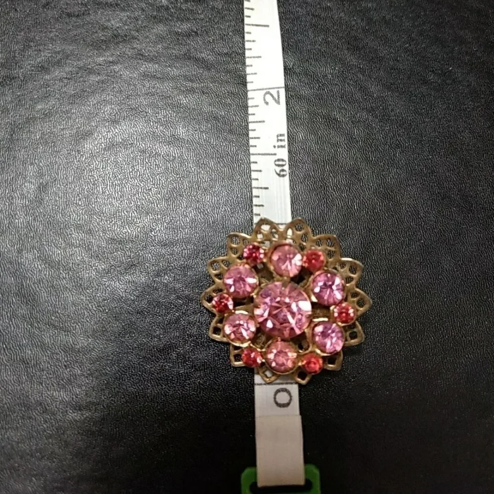Gold tone flower pin with pink stones brooch